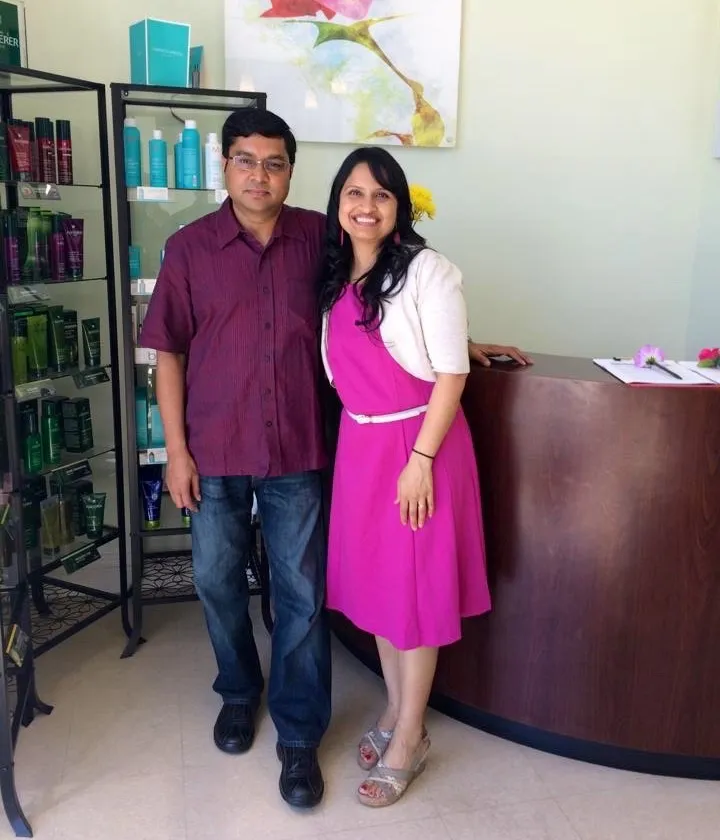 Sri and Rama standing at the front desk of Beauology salon
